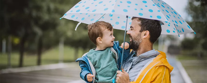 Father and son under the rain