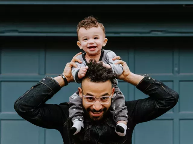 A dad with his son on his shoulders