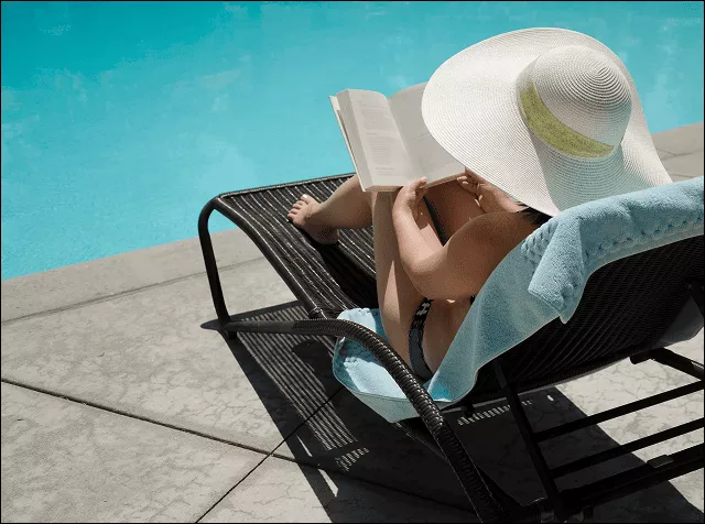 girl reading near a pool