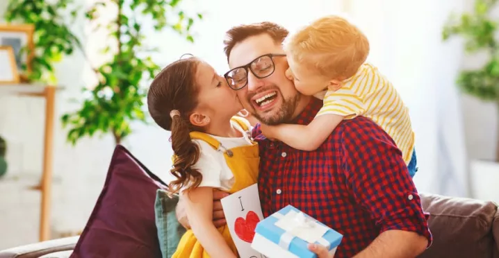Father with his girls receiving gifts