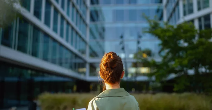 women in front of green building