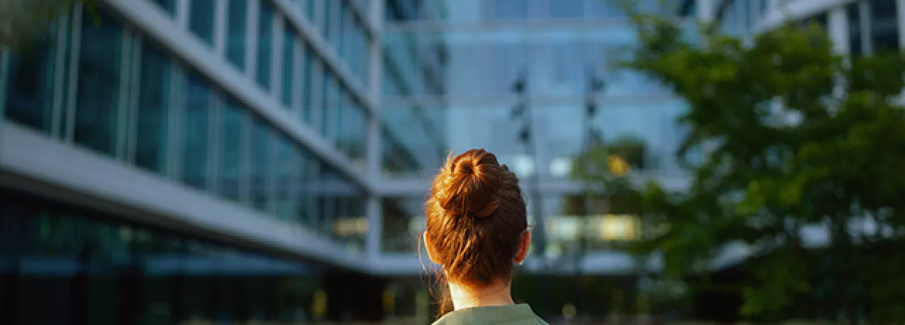women in front of green building