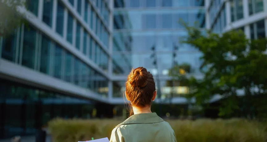 women in front of green building