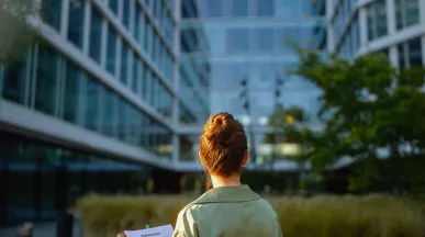 women in front of green building