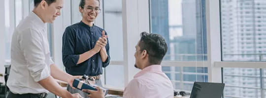 peoples offering gifts in a company